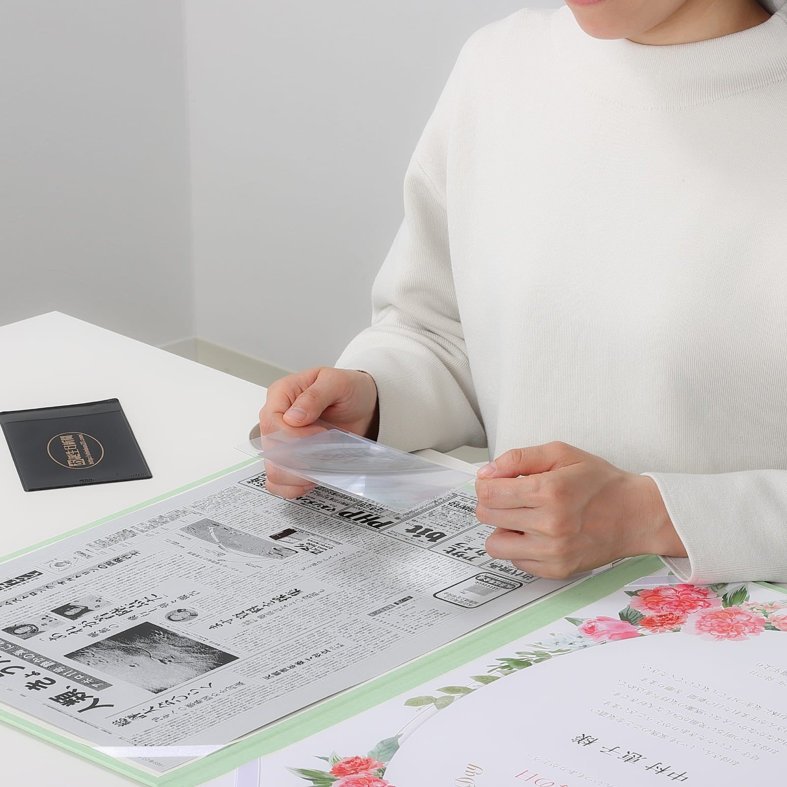 みえルーペで新聞紙面を2倍に拡大して楽しむ様子